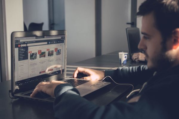 Person using a laptop in a modern office, representing hiring